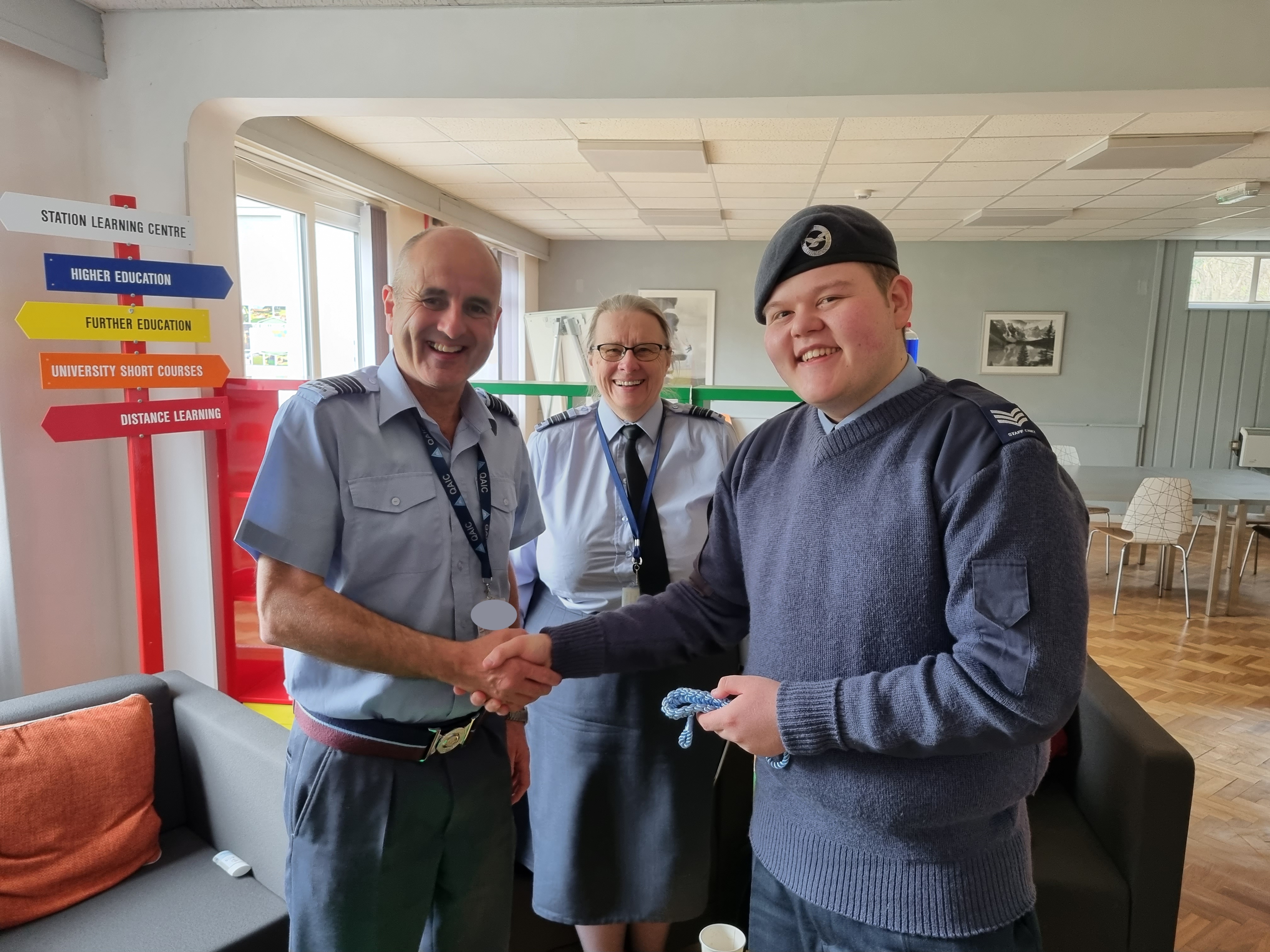 Wing Commander Ian Revell shaking hands with cadet